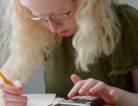 photo of a child using a talking graphing calculator