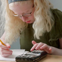 photo of a child using a talking graphing calculator