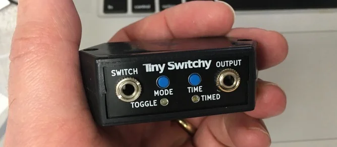 a hand holding Tiny Switch box